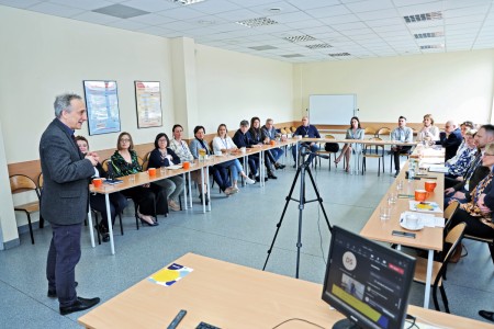 Conference participants sitting at tables, listening to the speech given by the Vice-Rector for Education, Professor Przemysław Nehring, PhD. Click to zoom the picture.