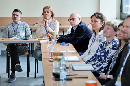 Conference participants sitting at the table. Click to zoom the picture.