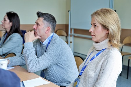 Conference participants sitting at the table. Click to zoom the picture.